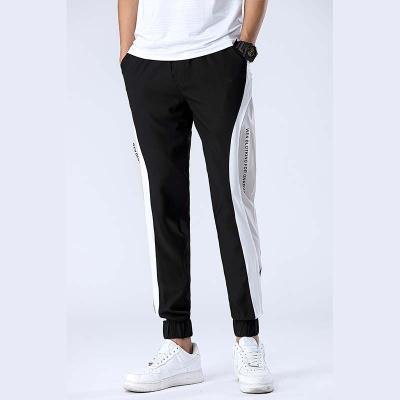 China Wholesale Black Loose Anti-wrinkle Polyester Breeches Anorak Pants Casual Men Pants for sale