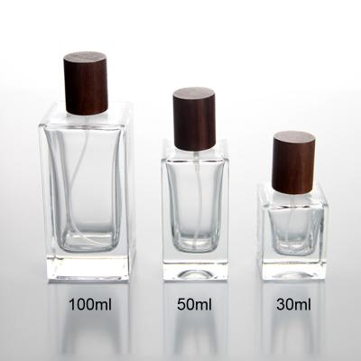 China Cosmetic Perfume Bottle 30 50 100ml With Rectangle Shape With Wooden Cap for sale