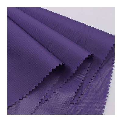 China Hot Selling Breathable 380t Polyester Taffeta Fabric 0.1cm Ripstop Oil Wax Down Jacket Fabric for sale