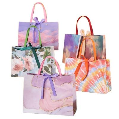 China Recycled Materials New Creative High Quality Luxury Oil Painting Bags Recycled Gift Paper Bag Shopping Christmas Wedding Packaging Bag With Ribbon for sale