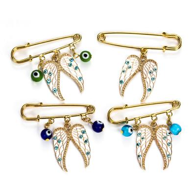 China Fashion Luxury Needle Angel Wing Brooches Turkish Blue Eye Pin Collar Pin Silk Scarf Brooch Hijab Pin for sale