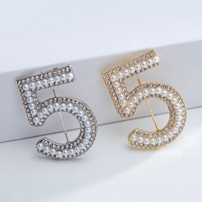 China Famous Designer Rhinestone Pearl Clothing ALLOY Number 5 Brooches Luxury Brooch Pins For Women for sale