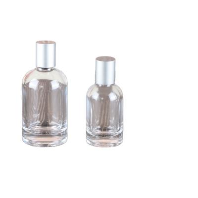 China 30ml 50ml 100ml Clear Round Shoulder Glass Perfume Cosmetic Spray Bottle for sale