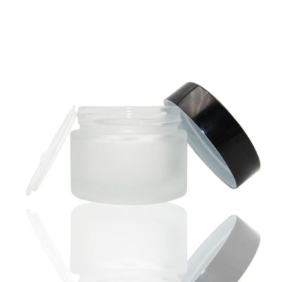 China Empty Frosted Clear Cosmetic Cream Jar Stocked In Facial White Black Round Glass 50g Small TOC for sale