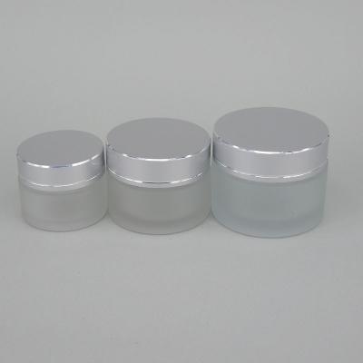 China Cosmetic Jar 50g Face Cream Cosmetic Jars Frosted Glass Jar With Silver Lid for sale