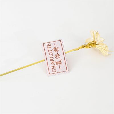 China Factory direct sales washable customized half-fold shiny pink gold silk label clothing woven label for sale