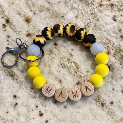 China Cute Fashion Sunflower Yellow Silicone Beaded Bracelet Key Chain For Mom Gift Wooden Beads Mom Key Chain Glitter Beads Bracelet Keychain for sale