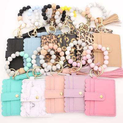 China 2022 hot sale fashion sunflower leopard silicone beads credit card holder leather wristband bracelet pu tassel key chain for sale