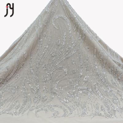 China Latest Viable Wholesale Fashion Wedding Dress Embroidery Veil Tulle Sequined Sequins Lace Up Trim Fabric Beads for sale