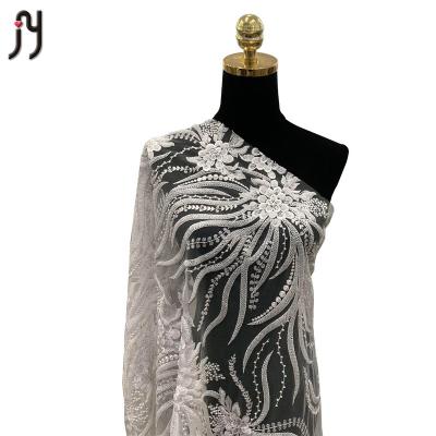 China Sequin 99050 Luxury White Bridal Embroidery Lace Beaded Lace Fabric for sale