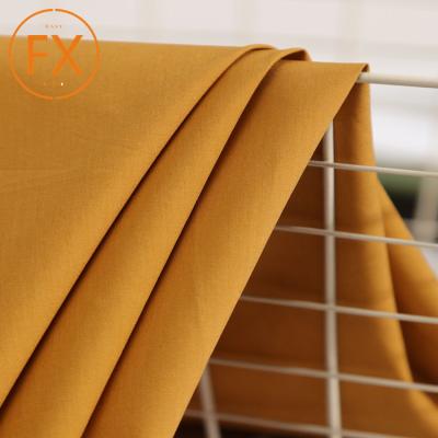 China Shrink-resistant comfortable plain dyed roll textile woven 100% cotton fabric for dress, shirts, blouses and pants for sale