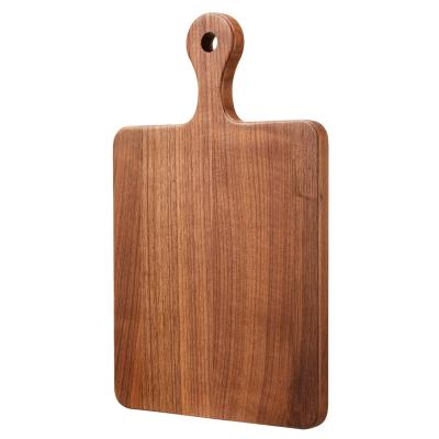 China Sustainable American Black Reversible Walnut Wood Cutting Serving Board With Handle for sale