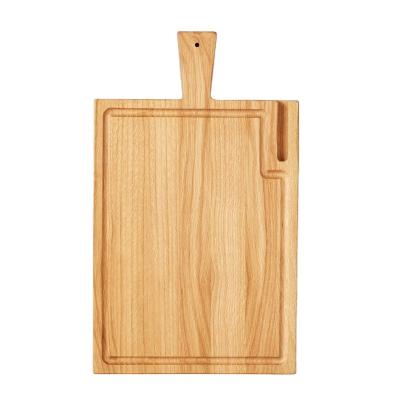 China Sustainable Handcrafted Solid Oak Wood Cutting Board With Phone Holder Slot for sale