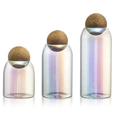 China High Borolicicate Viable Unique Colorful Laser Colors Storage Spice Candy Bottle Glass Jar With Cork Ball Lid for sale