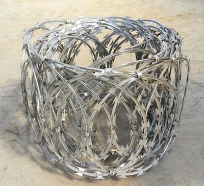 China Razor Barbed Wire Flat Wrap Coils 500mm Diameter Galvanized For Sale for sale