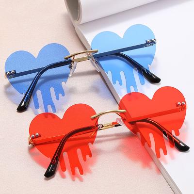 China Fashion Yuxun Sunglasses Shape Newest Halloween Party Rimless Funny Love Heart Flowing Style Rimless Sunglasses 2022 Women for sale