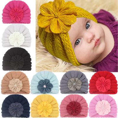 China Baby Turban Hat 2021 COMMON Fashion Solid Color Knitted Flower Hat Baby Winter for sale