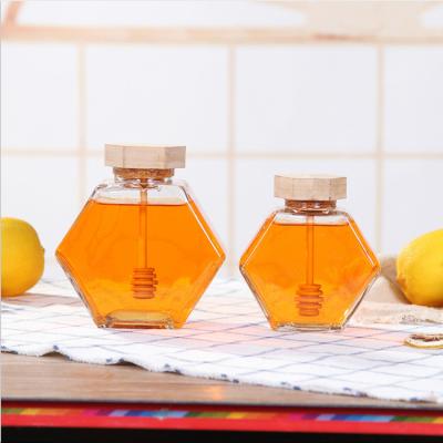 China Food costom hot sale food glass honey jar with wooden lid for sale