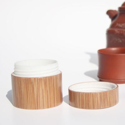 China Custom Bamboo Wooden Cosmetic Packaging Containers Plastic Bottle With Bamboo Lid for sale