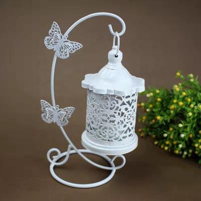 China Amazon Hot Selling Home Decoration Butterfly Candle Holder Wrought Iron Cavity Hook Wedding Decoration Creative Hanging White Candlestick for sale