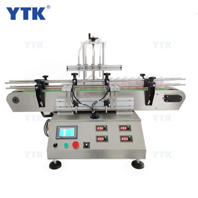 China Desktop Four Head Automatic Food Magnetic Liquid Pump Bottle Liquid Filling Machine With Conveyor For Perfume Filling Machine for sale