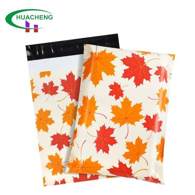 China Durable custom full color poly pattern printing colorful mailer for clothes maple leaf shipping courier mailer bag with logo for sale