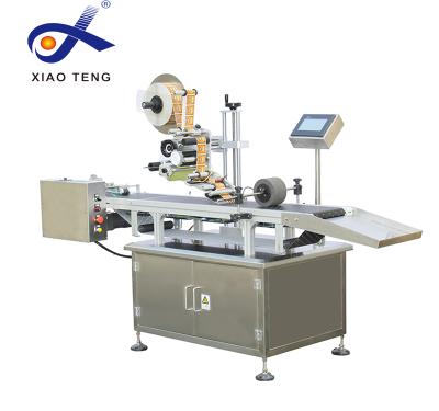 China PM-100A Automatic CLOTHING Feeder Flat Page Labeling Machine With Printing Labels for sale