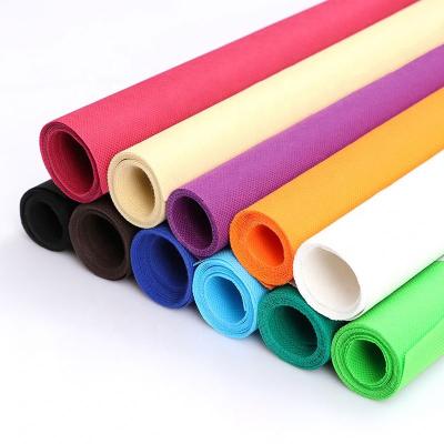 China Waterproof stock nonwoven fabric red color 100% polypropylene spunbonded nonwoven fabric roll for bags made for sale