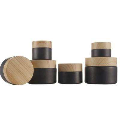 China Personal Care 5g 10g 20g 30g 50g Matte Black Liner Cosmetic Face Cream Glass Jar With Water Wood Grain Screw Lid Airtight Seals for sale