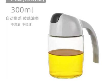 China Household products handle 300ml 600ml 630ml argan oil cooking glass bottle with automatic dispenser soy sauce pickle jar soybean use with scale for sale