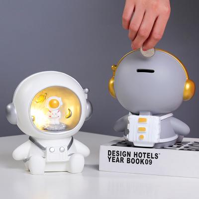 China Modern Cute Creative Desktop Astronaut Decoration Children Piggy Bank Led Astronaut Money Box for sale