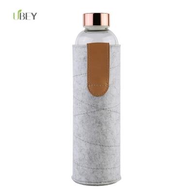 China Rose Gold Lid BPA Free Viable Shatterproof Glass Water Bottle 750ml With Private Label Felt Sleeve for sale