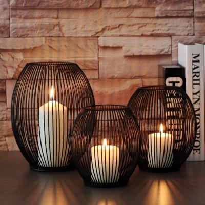 China Wholesale Home Decoration Industrial Fashion Candle Holder Egg Shape Candle Holder Dining Table Top Black Simple Metal Craft Candlestick for sale