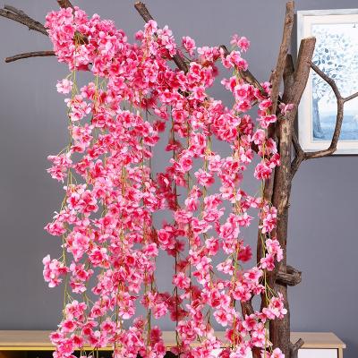 China Realistic Artificial Flowers Home Decor Vines Garland Wall Hanging Plants Simulation Cherry Blossom Plastic Rattan for sale