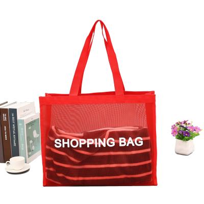 China Luxury Red Handled Mesh Summer Beach Bag Hollow Out Shoulder Bag Large Fishing Net Tote Bag for sale