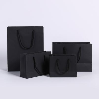 China Wholesale Biodegradable Stored Kraft Paper Bags White Color Black Biodegradable Clothes Paper Bags Shopping Packaging Bags With Strings for sale