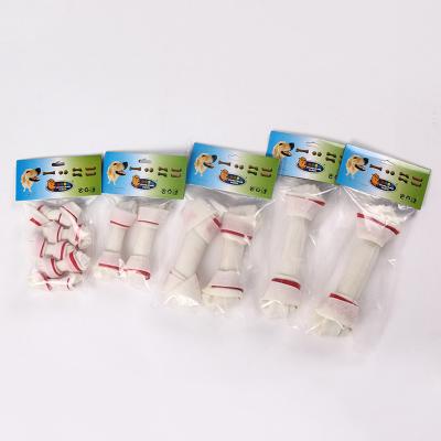 China Viable Many Size Organic Healthy Pet Treat Bleached Rawhide Knot White Red Bone Dog Snacks for sale