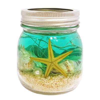 China Handmade Ocean Breeze Glass Jar Perfume Gel Wax Tin Lid Sparkling String Light Scented Gel Wax LED Candle for sale