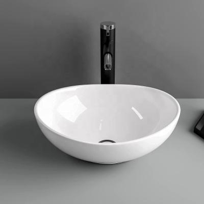 China Contemporary Oval White Ceramic Vessel Sink Modern Egg Shape Above Counter Bathroom Vanity Bowl for sale