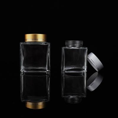 China Srew-on Lid Wholesale 30Ml 50Ml 100Ml Glass Personality Transparent Closed Square Glass Jar For Food With Metal Screw Lid for sale