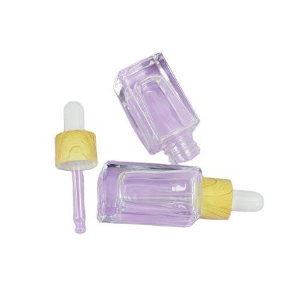 China Impresión en serigrafía 10 ml 15 ml Embalaje de vidrio Botella de forma cuadrada para aceite esencial para el cabello en venta