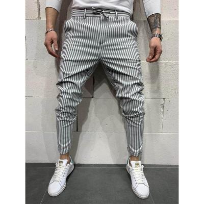 China Polyester/cotton men's slim fit small foot casual pants lace up striped pants fashion plaid elastic skinny pants men for sale