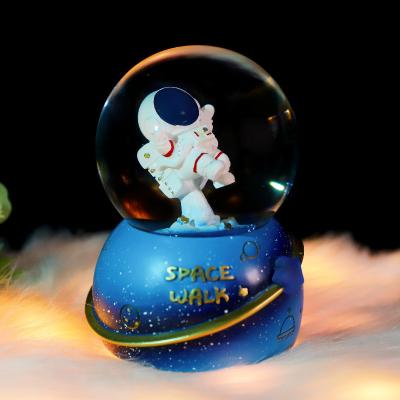 China Astronaut Cosmic Auto Snow Space Rocket Europe Star Lights Crystal Ball Music Box Colorful New Year's Eve Decoration Gift for sale