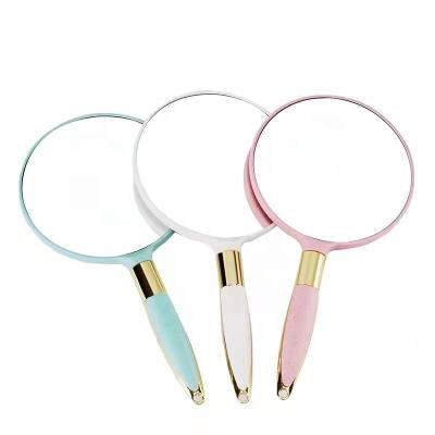 China Traditional Round Mini Portable Cosmetic Tool Single Side Handheld Makeup Mirror With Handle for sale