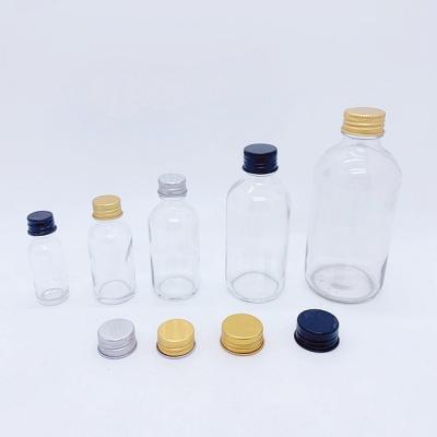 China Wholesale Cosmetic 16oz 500ml 8 16 oz 250 500 1000 ml g cc Volume Clear Boston Round Liquid Glass Bottle With Bakelite Cap Trim for sale