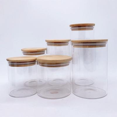 China Cheap Freshness Preservation Borosilicate Glass Storage Jar With Bamboo Lid For Tube Shaped Storage Glass Jar For Spice Glass Jar With Wooden Lid for sale