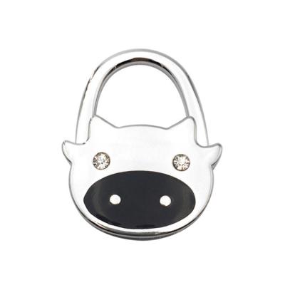 China 2020 New Wholesale Portable Europe Metal Purse Hook Table Cow Shape Bag Hanger For Ladies for sale