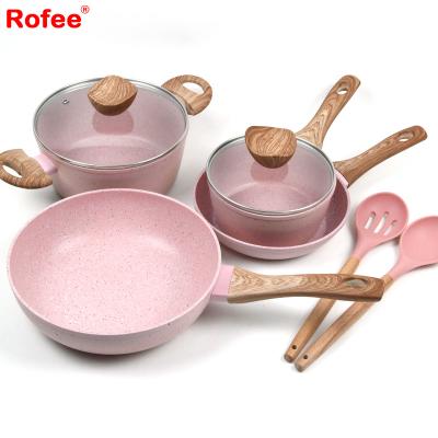 China Family Sustainable Use Non Stick Color Safe Pink Cookware Set With Wooden Style Handle for sale