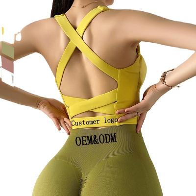 China Breathable Gym Wear Women's U-Neck Hollow Push Up Cross Back Sports Bra Crop Yoga Top for sale