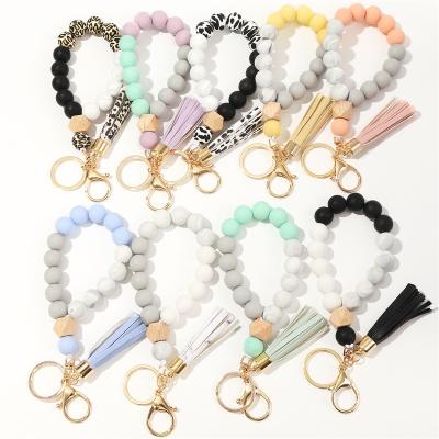 China Key Ring PU Wooden Tassel Anti Acorn Daily Life Daily Life Monogram Silicone Bead Bangle Key Ring Loss Bracelet for sale